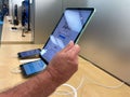 A hand holding a 10.9 inch iPad Air tablet computer at an Apple store Royalty Free Stock Photo