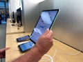 A hand holding a 10.9 inch iPad Air tablet computer at an Apple store Royalty Free Stock Photo