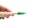 Hand holding a jack instrument cable isolated on a white background. Royalty Free Stock Photo