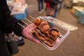 Hand holding Japanese street food close up Grilled Oysters and e Royalty Free Stock Photo