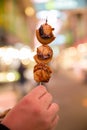 Hand holding Japanese street food close up Grilled Oysters with Royalty Free Stock Photo