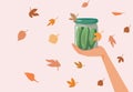 Hand Holding a Jar of Pickles in Autumn Background Vector Illustration Royalty Free Stock Photo