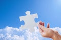 Hand holding a jigsaw puzzle and sky Royalty Free Stock Photo