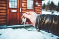 Hand holding a key on the background of the house. Real estate sale concept Royalty Free Stock Photo