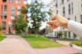 Hand holding keys on the background of a new building, construction concept. Buying real estate, housing, apartments. Private yard Royalty Free Stock Photo