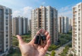 A hand holding keys in front of a building Royalty Free Stock Photo