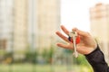 Hand holding keys in front of building Royalty Free Stock Photo