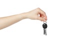 Hand holding keys to apartment on white background. Royalty Free Stock Photo