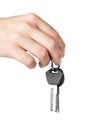 Hand holding keys to apartment on white background. Royalty Free Stock Photo