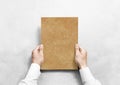 Hand holding kraft blank paper sheet mockup, Royalty Free Stock Photo