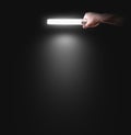 Hand holding lamp near the wall, . Idea, logo, poster