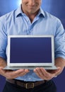 Hand holding laptop with blue background Royalty Free Stock Photo