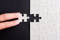 Hand-holding last piece white paper jigsaw puzzle game last pieces put to place Royalty Free Stock Photo