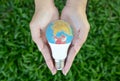 Hand is holding the LED bulb with nature background for save the earth concept Royalty Free Stock Photo