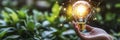 Hand holding light bulb amidst green plants, digital web Royalty Free Stock Photo