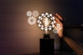 Hand holding light bulb and cog inside. Idea and imagination. Creative and inspiration. Innovation gears icon with network Royalty Free Stock Photo