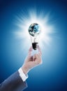 Hand holding light bulb with globe Royalty Free Stock Photo