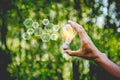 Hand holding light bulb with icons energy sources for renewable,natural energy Royalty Free Stock Photo