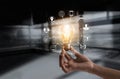 Hand holding light bulb with icons multimedia and customer network connection Royalty Free Stock Photo