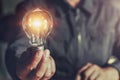 hand holding light bulb. idea concept with innovation Royalty Free Stock Photo