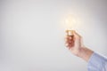 Hand holding light bulb, new ideas for discovery inspiration. Royalty Free Stock Photo