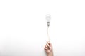 Hand holding  light bulb on rope floating on white background with texting space, idea concept Royalty Free Stock Photo