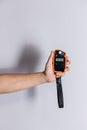 Hand holding light exposure meter, a photograph device for measuring illumination on white background. Hand held light meter isola Royalty Free Stock Photo