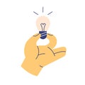 Hand holding lightbulb icon. Light bulb, electric lamp as symbol of creative ideas, insights and new solutions
