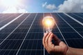 hand holding lightbulb on solar panel concept clean energy in nature Royalty Free Stock Photo