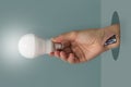 Hand holding lightbulp wit Insert the battery in the arm Royalty Free Stock Photo