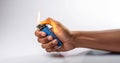 Hand Holding a Lit Lighter A closeup of a hand igniting a blue lighter symbolizing fire ignition warmth action and control Royalty Free Stock Photo