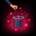 Hand holding magic wand over a magical top hat Royalty Free Stock Photo