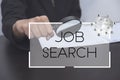 Hand holding magnifier with job search text. concept employment