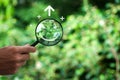 Hand holding a magnifying glass highlighting a happy smile. Concept of positive thinking, mental health, Royalty Free Stock Photo