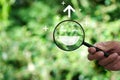 Hand holding a magnifying glass highlighting a happy smile. Concept of positive thinking, mental health, Royalty Free Stock Photo