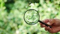 Hand holding a magnifying glass highlighting a happy smile. Concept of positive thinking, mental health, Royalty Free Stock Photo