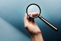 A hand holding a magnifying glass isolated on a white background Ai generated