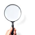 Hand holding magnifying glass - isolated on white background Royalty Free Stock Photo