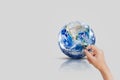 Hand holding magnifying glass to look at blue planet earth. Royalty Free Stock Photo