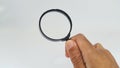 Hand holding magnifying glass on white background Royalty Free Stock Photo