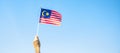 Hand holding Malaysia flag on blue sky background. September Malaysia national day and August Independence day Royalty Free Stock Photo