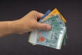 Hand holding Malaysia Ringgit MYR Currency Bank Notes. Royalty Free Stock Photo