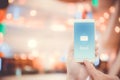 Hand holding man check and sending message with email in a phone on bokeh background. Royalty Free Stock Photo