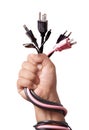 Hand holding Many home use plugs unplugged into electric power