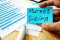 Hand is holding Market Sizing inscription Royalty Free Stock Photo