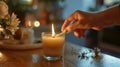 A hand holding a match ready to light the candles and start an evening of relaxation indulgence and selfcare Royalty Free Stock Photo