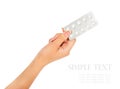 Hand holding medical drugs - full silver leaflet of white pills Royalty Free Stock Photo