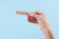 Hand holding medical plaster on blue background Royalty Free Stock Photo