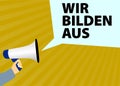 Hand holding megaphone or bullhorn with speech bubble and text WIR BILDEN AUS