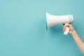 Hand holding megaphone on light blue background. Web banner design. AI Image Royalty Free Stock Photo
